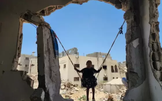 طفل من غزة بين ركام المنزل