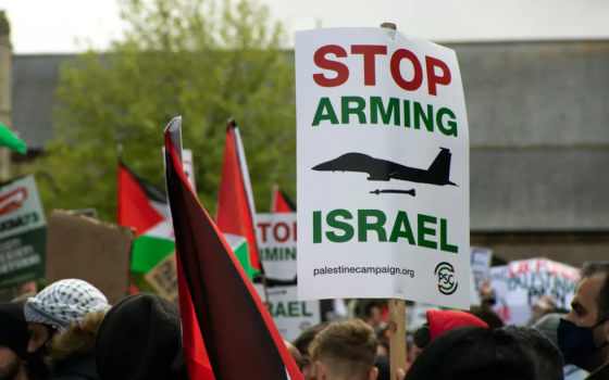 لافتة تدعو لوقف تسليح الاحتلال